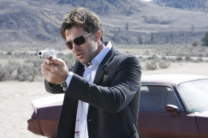 Detective John Sheppard takes aim in season five's "Vegas." Photo by Eike Schroter and copyright The Sci Fi Channel